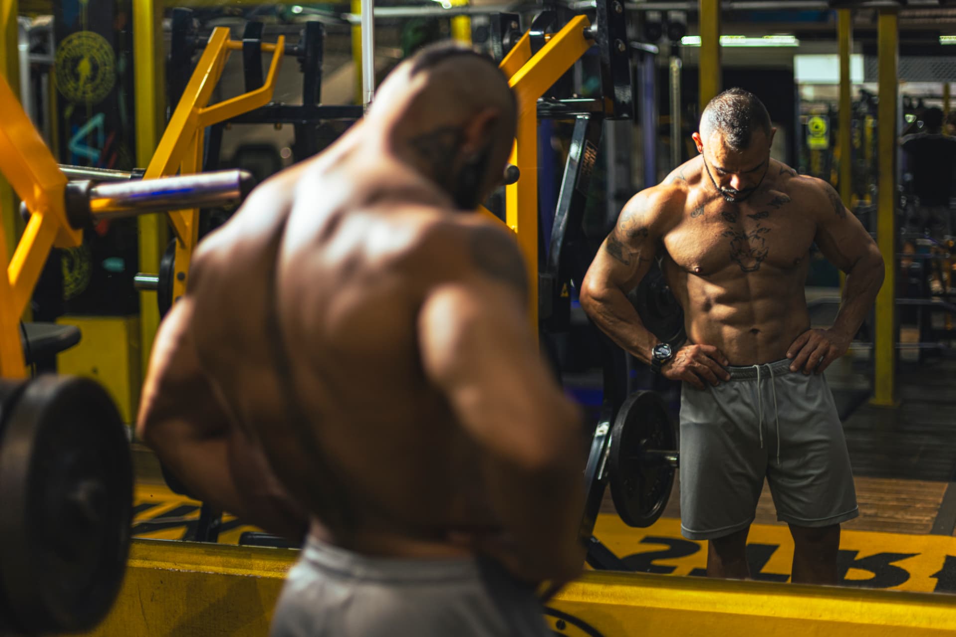 Michael Greenland checking his physique in the gym mirror
